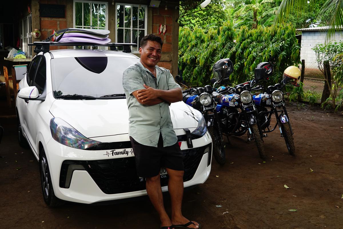 Elmer Flores, owner of Panda on Wheels, with the taxi and rental motorcycles
