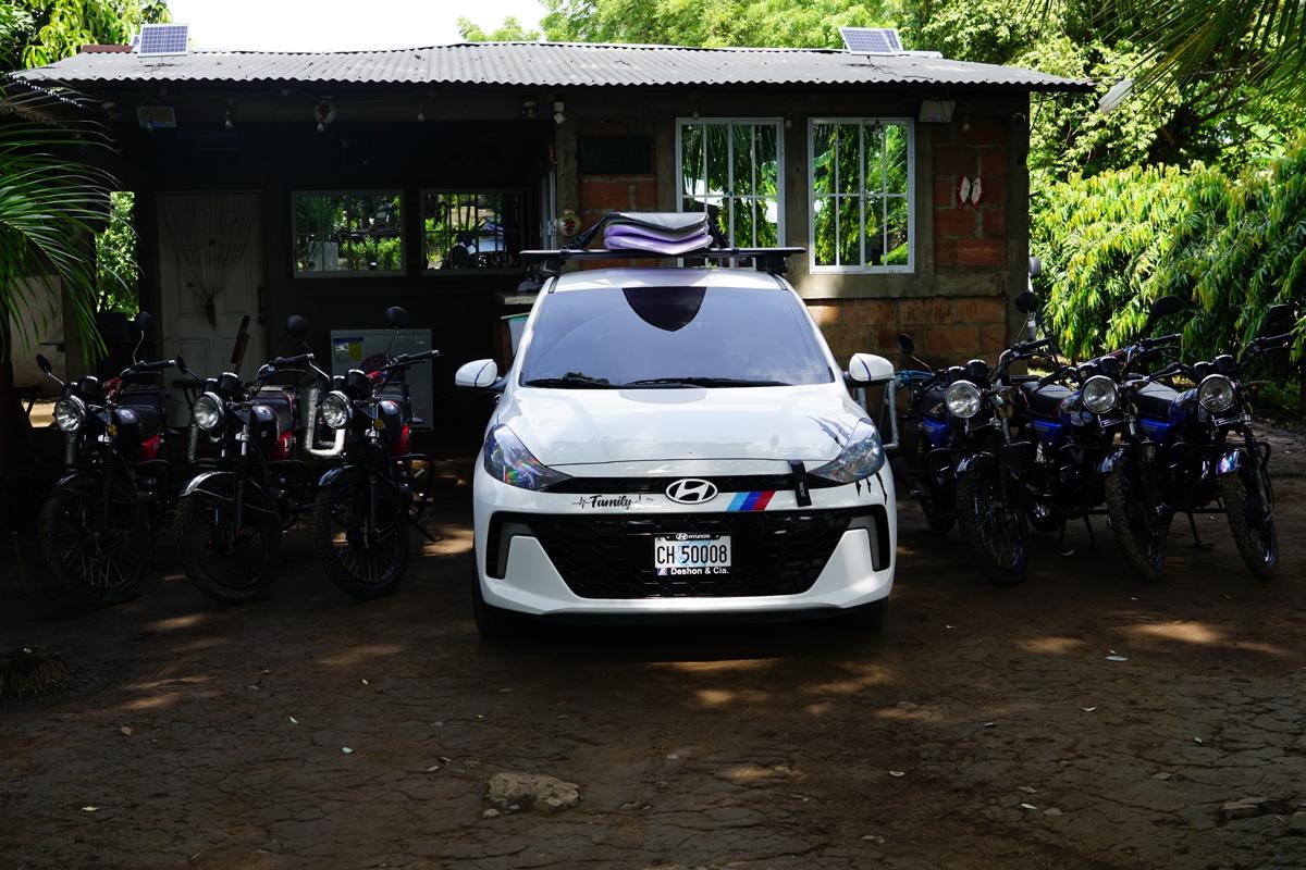 The Panda on Wheels house with the taxi in the middle and motorcycles on both sides